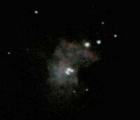 The Trapezium star cluster in the Orion Nebula (M42), photographed with a DSLR camera pointed through a telescope eyepiece. South is up and East is to the right. Click for a larger version, 4 KB (Copyright Martin J Powell, 2006)