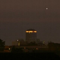 Venus rising at dawn behind a tower block. Click for full-size picture, 191 KB (Copyright Martin J Powell, 2011)
